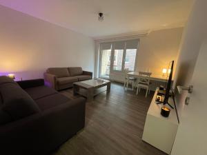 ein Wohnzimmer mit einem Sofa und einem Tisch in der Unterkunft Cozy apartment city nightlife in Düsseldorf