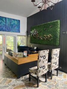 a dining room with a table and two chairs at Hotel Aromax del Campestre in Medellín