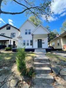 a white house with a stone path in front of it at Rotherwood Roost / 2BR/1BA Apartment near UE in Evansville
