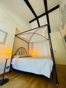 a bedroom with a canopy bed in a attic at Casa Caroli - intera casa ad Alba, LANGHE UNESCO in Alba