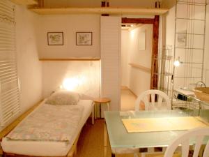 a small room with a bed and a table at Ferienwohnung Altes Haus 1 in Lindau