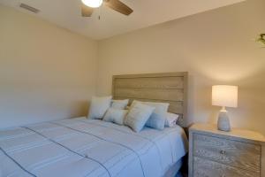 a bedroom with a large bed with blue pillows at Ideally Located Palm Harbor Condo Walk Downtown! in Palm Harbor