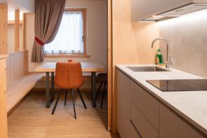 a small kitchen with a sink and a table at Chalet al Tabià in Bormio
