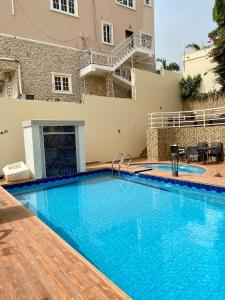 a large swimming pool in front of a building at GLOVIS LUXURY APARTMENT in Abuja