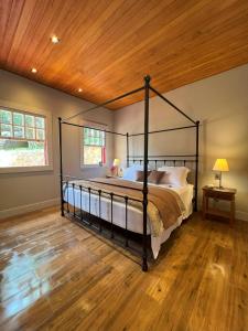 a bedroom with a large bed with a wooden ceiling at Pousada Boutique Villa Chafariz Tiradentes in Tiradentes