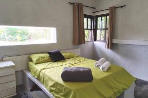 a bedroom with a yellow bed with a window at Casa de Campo Diamantina MG in Diamantina