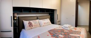 a bedroom with a large bed with pillows at Casa Fedele in LʼAquila
