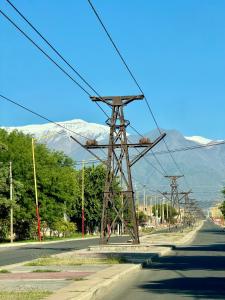 a group of electricity poles on a street with a mountain at Casa Del Cable Carril in Chilecito