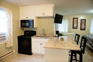 a kitchen with white cabinets and a counter top at Berry Patch BnB in Lebanon