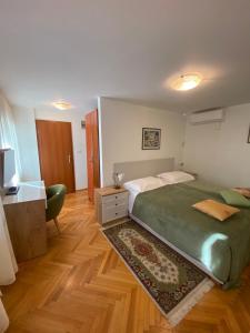 a bedroom with a bed and a desk and a television at Rooms Base in Split