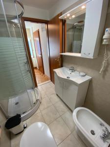 a bathroom with a sink and a toilet and a shower at Rooms Base in Split