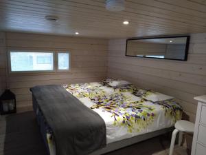 a bedroom with a bed and a mirror in it at Koivuniemen Tila 3 in Säkylä