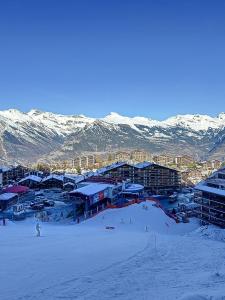 a group of people skiing down a snow covered slope at Haute-Nendaz - Ski-in/ski-out - Le Mont-Fort in Nendaz