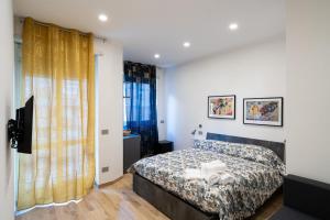 a bedroom with a bed and a television at La dolce vita rooms in Rome