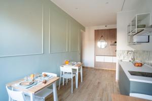 a kitchen with two tables and chairs in a room at La dolce vita rooms in Rome +17 photos