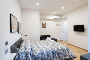 a bedroom with a bed and a flat screen tv at La dolce vita rooms in Rome