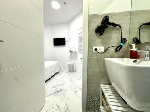 een badkamer met een wastafel en een telefoon aan de muur bij Alcalá Retreat: Ocean View & Modern Comfort in Alcalá +57 foto's