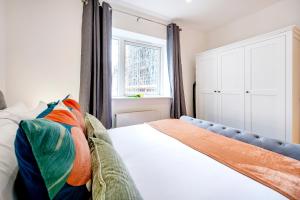 a bedroom with a bed and a window at Welcome London - New Oxford Street in London