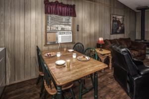 a living room with a table and a couch at Sacony, Cabin at Ruidoso in Ruidoso +8 photos