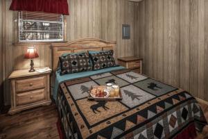 a bedroom with a bed with a tray of food on it at Sacony, Cabin at Ruidoso in Ruidoso