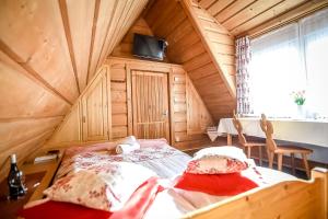 a bedroom with a bed in a wooden house at Domek na Harendzie in Zakopane