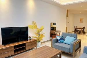 a living room with a large flat screen tv at F13 R&F 2BR Swimming Pool @ CIQ in Johor Bahru