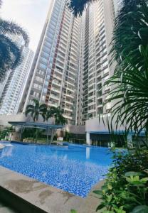 a large apartment building with a large blue swimming pool at F13 R&F 2BR Swimming Pool @ CIQ in Johor Bahru