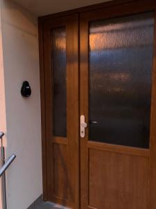 a wooden door with a window in a room at Přízemí v parku. (Apartment no.8) in Znojmo