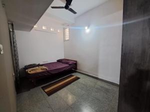 a small room with a bed and a ceiling at 3 Bedroom Duplex Villa With Private Pool Bangalore in Bangalore