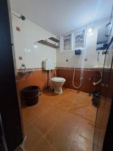 a bathroom with a toilet and a sink at 3 Bedroom Duplex Villa With Private Pool Bangalore in Bangalore