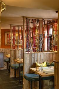 a restaurant with wooden walls and wooden tables and chairs at The Bittescombe Inn in Upton