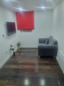 a living room with a couch and a tv at 1 Bedroom Apartment in Daventry