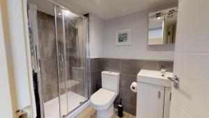 a bathroom with a toilet and a shower at The Stratford Suite Dunara 6 in Leamington Spa