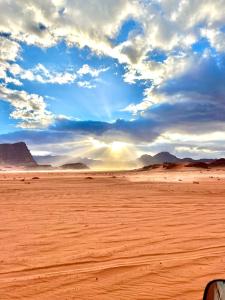 a view of a desert with a cloudy sky at STAR of Wadi Rum in Wadi Rum