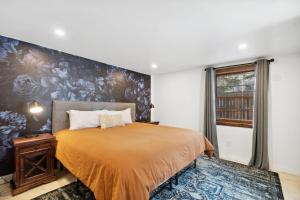a bedroom with a bed and a large wall at 5 Bd Cabin W Private Hot Tub in Allenspark