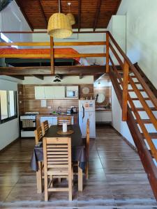 a dining room with a table and a kitchen at Complejo Boulevard in Villa Ciudad de America