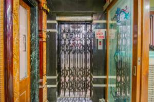 a door with a metal gate in a building with graffiti at SPOT ON Hotel Green Valley in Vijayawāda