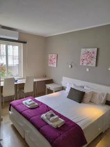 a bedroom with a large bed with towels on it at Villa Katerina in Chania