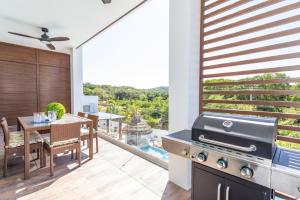 a kitchen with a grill and a dining room with a view at Acqua di Mare Resort in West Bay