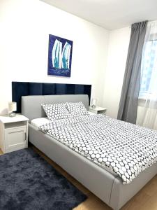 a bedroom with a white bed and a window at Ocean Apartment in Zagreb