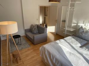 una camera con letto, divano e lampada di Appartement "Stadtnest" im Zentrum von Bautzen mit WLAN und gratis Kaffee a Bautzen