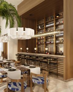 a restaurant with white tables and chairs and a bar at Savotel in Golem +6 photos