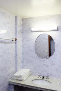 a bathroom with a sink and a mirror at Days inn by Wyndham Uberlândia in Uberlândia