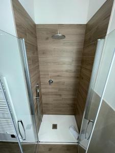 a bathroom with a shower with a glass door at La Casina di Cinzia in San Gimignano