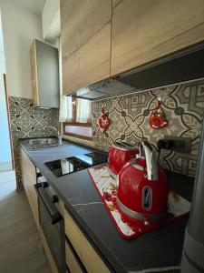 a kitchen with a red tea kettle on a counter at La Casina di Cinzia in San Gimignano