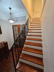 - un escalier dans une maison dotée de parquet et d'un lustre dans l'établissement Spacious Retreat for Large Groups, à Lafayette