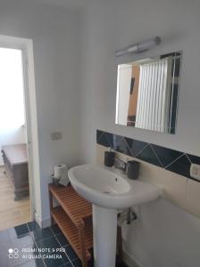 a bathroom with a sink and a mirror at APPARTAMENTO JLENIA in Cisterna di Latina