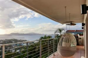 a balcony with a view of the ocean at Mandavilla Rose - Inspired USVI in Cruz Bay