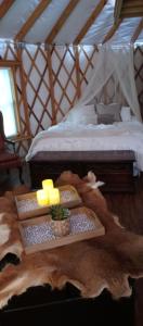 een slaapkamer met een bed en een tafel met kaarsen bij Madison's ONLY yurt experience! in Vevay