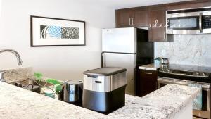 a kitchen with a refrigerator and a counter top at Blue Paradise Suite Free Parking in Honolulu